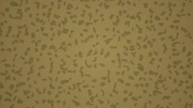 Scattered green clover shapes appear on a warm goldenyellow background resembling a textured fabric surface.