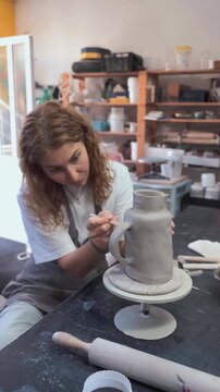 Ceramic Maker Shaping Pot in Studio