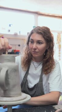 Woman Shaping a Ceramic Pot in Porto Workshop