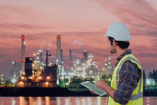 Technician with tablet interacting with future tech at oil refinery port, original composite, not AI generated.