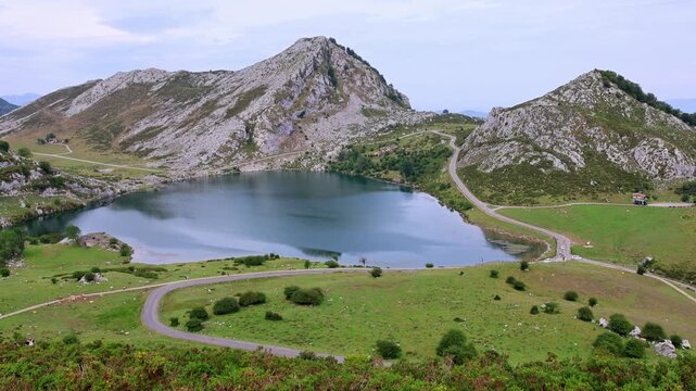 Wide panoramic view of alpine lake Covadonga and mountain range Picos de Europa Asturias Spain