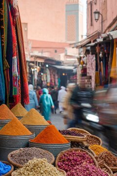 Market scene with spice piles in a busy street in Marrakech, Morocco, during the day