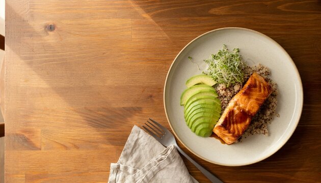 Salmon fillet served on a plate with quinoa and sliced green apples at a table