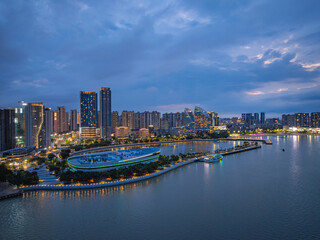 Fototapeta premium Zhanjiang Jinshawan bay night view with illuminated city skyline along the riverbank
