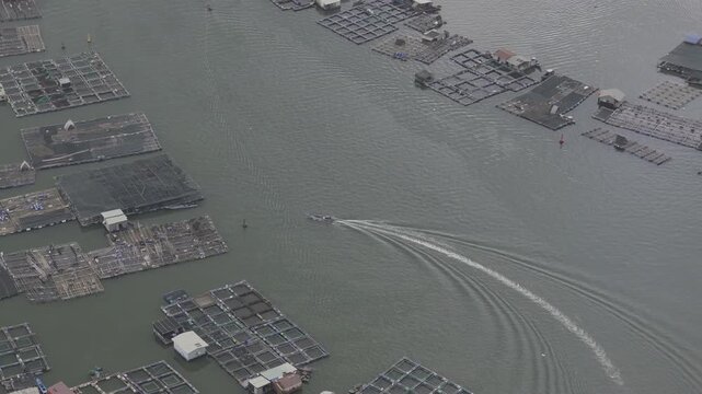 Aerial drone footage of oyster farming in Long Son, Ho Chi Minh City, Vietnam, showcasing traditional aquaculture, floating oyster farms, coastal fishing industry and sustainable seafood production.