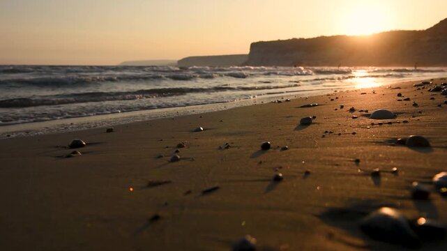 Sea waves washing beach at sunset near Kourion cliffs, Limassol, Cyprus 