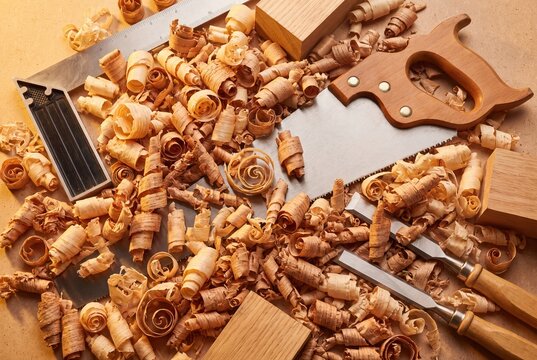 Carpentry workshop background with hand tools and wood shavings