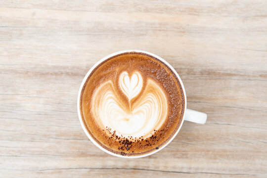 Closeup of cappuccino latte heart on dark old grunge with top view