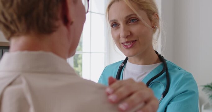 Nurse provides patient support and reassurance during consultation. In medical clinic, she listens with empathy, offers care, and explains treatment for health. Warm care, medicine and trust idea.