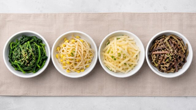 Korean namul vegetable side dishes arranged on linen