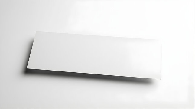Blank White Rectangular Business Card or Name Tag on a White Surface with Subtle Shadowing