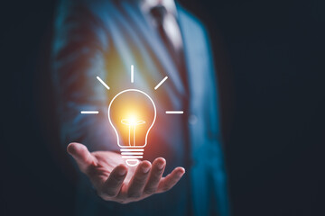 A Businessman hand showing light bulb for thinking new idea concept. Innovative technology with innovation. Inspiration of ideas for sustainable business development and communication concepts © STPDC Studio