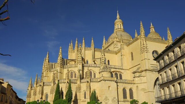 Gothic pinnacles and domes of Segovia Cathedral framed by historic city buildings