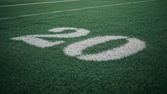 Number 20 painted on a green grass field.
