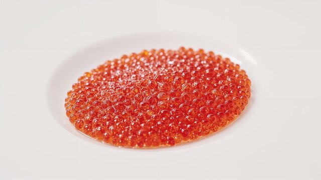 Rich red caviar on a white background, emphasizing its texture and color.