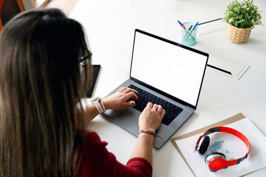 Woman working on laptop in modern office space