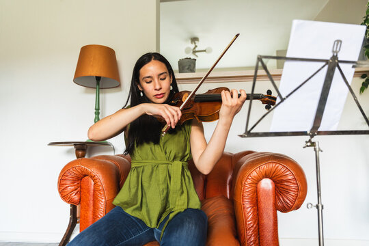 Low Angle View of Young Woman Playing Violin