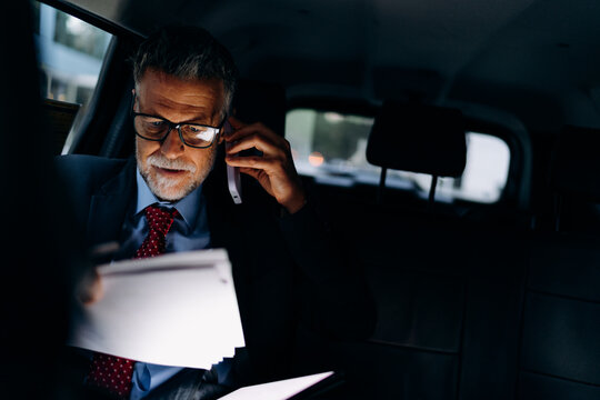 A man talking on a mobile phone in a car