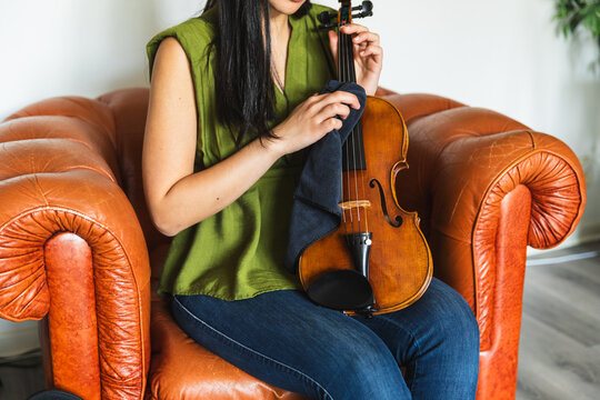 Cropped Shot of Hands Cleaning a Violin Body
