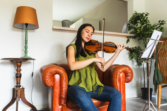 Concentrated Female Violinist Practicing Classic Music