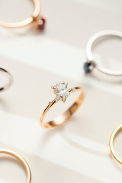 Elegant Gold Diamond Engagement Ring Close-Up Among Many Other Rings