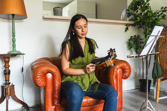 Violinist Attaching Shoulder Rest to Violin Before Practice