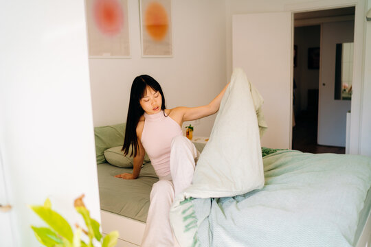 A woman getting out of bed