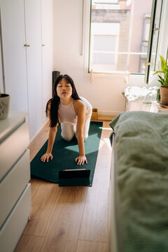 A woman doing yoga at home