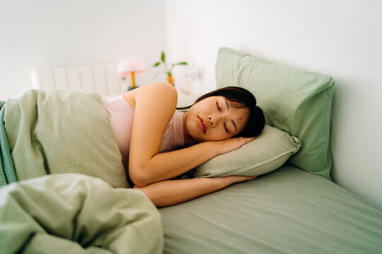 A woman sleeping in a bed