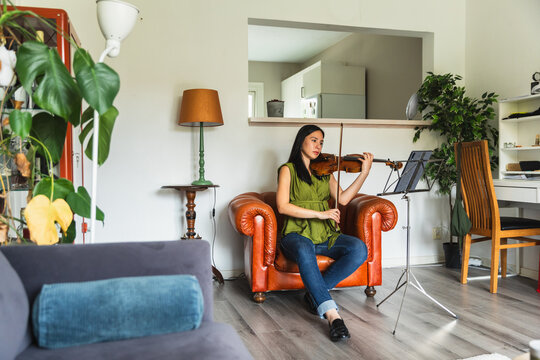 Full Shot of Female Musician Playing Violin at Home