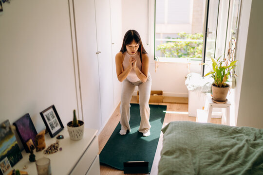 A woman doing yoga at home