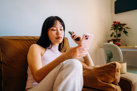 A woman using a mobile phone at home