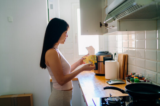 A woman making tea in the kitchen