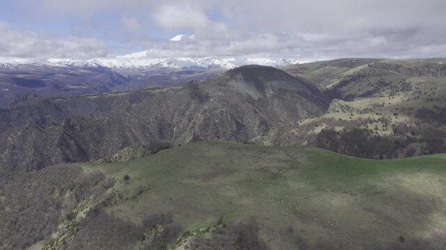 A drone video of the Caucasus Mountains, the Dzhily‑Su Valley, and the Pkhia Pass, Arkhyz, Russia, 2026.

