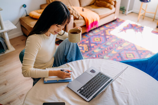 A woman using a laptop at home