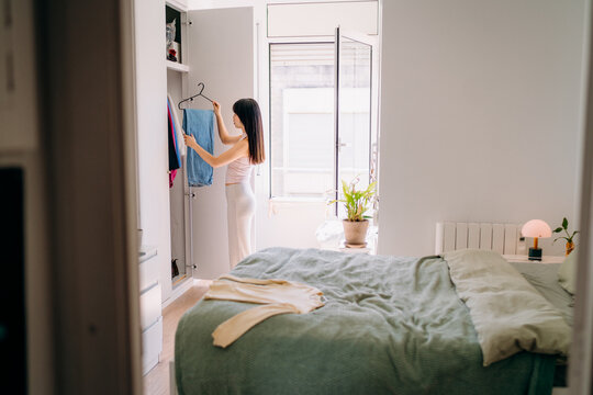 A woman choosing clothes at home