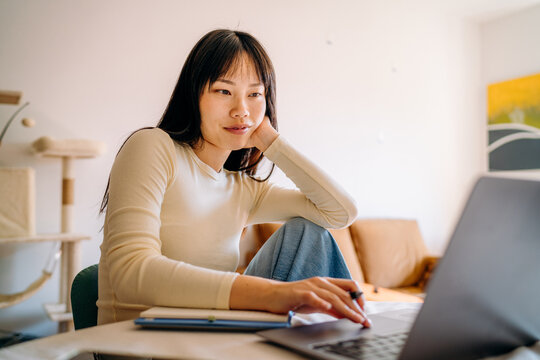 A woman using a laptop at home