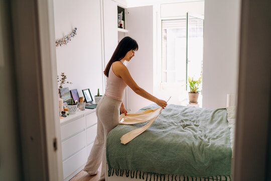 A woman choosing clothes at home