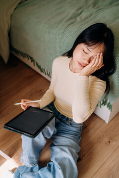 A woman using a tablet at home