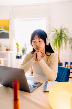 A woman using a laptop at home