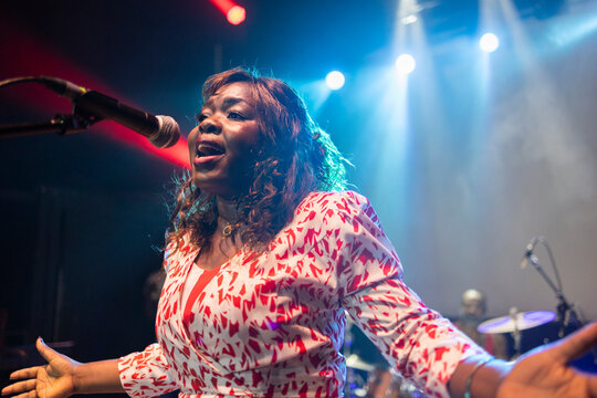 African american singer performing live music on stage