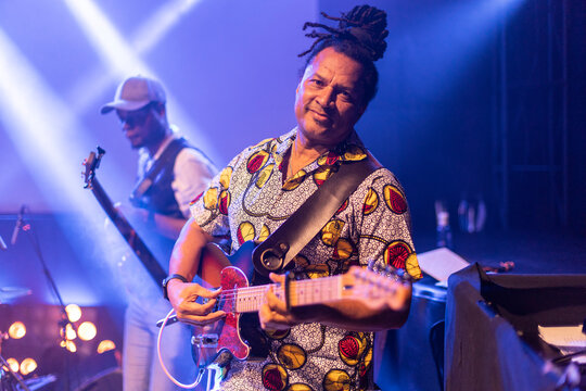 Musician playing electric guitar at live concert