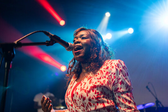 African american woman performing live music on stage