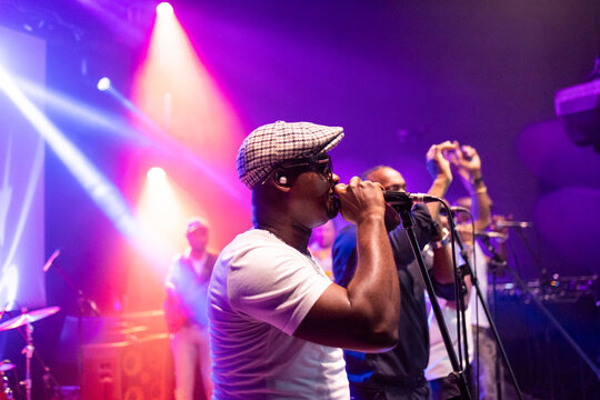 Black male singer performing live on stage
