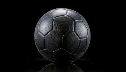 Naklejka premium Black soccer ball on black background. Dark football isolated for professional sports design.