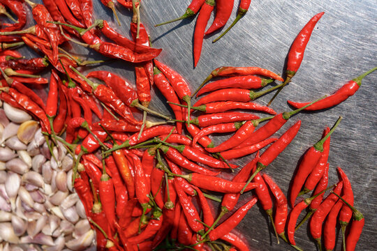 Chili Peppers and Garlic on a Metal Surface