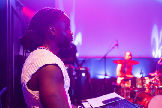 Musician performing live on stage during concert