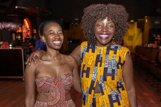 Smiling black women celebrating friendship and cultural style