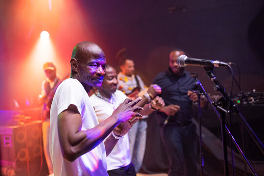 African musician performing energetic live music on stage