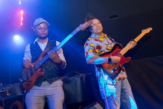 Musicians playing live music on stage, performing during concert